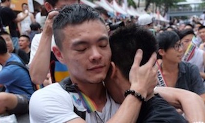 Same-sex activists hug outside the parliament in Taipei on May 24, 2017 as they celebrate the landmark decision paving the way for the island to become the first place in Asia to legalise gay marriage.
Crowds of pro-gay marriage supporters in Taiwan on May 24 cheered, hugged and wept as a top court ruled in favour of same-sex unions. / AFP PHOTO / SAM YEH        (Photo credit should read SAM YEH/AFP/Getty Images)